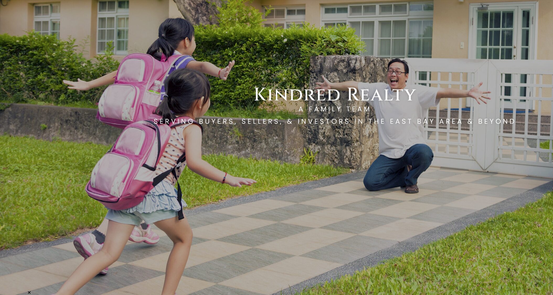 Father greets children in front yard