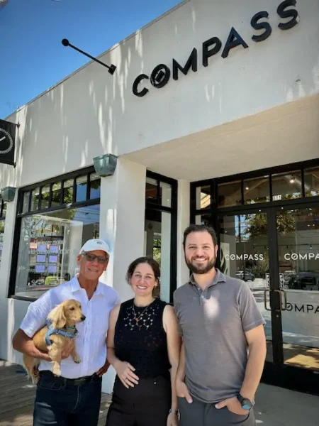 The Kindred Realty Team (Jeff Weissman, Mikayla Weissman, Orr Harari) and their dog in front of the Compass real estate office in Berkeley, CA.